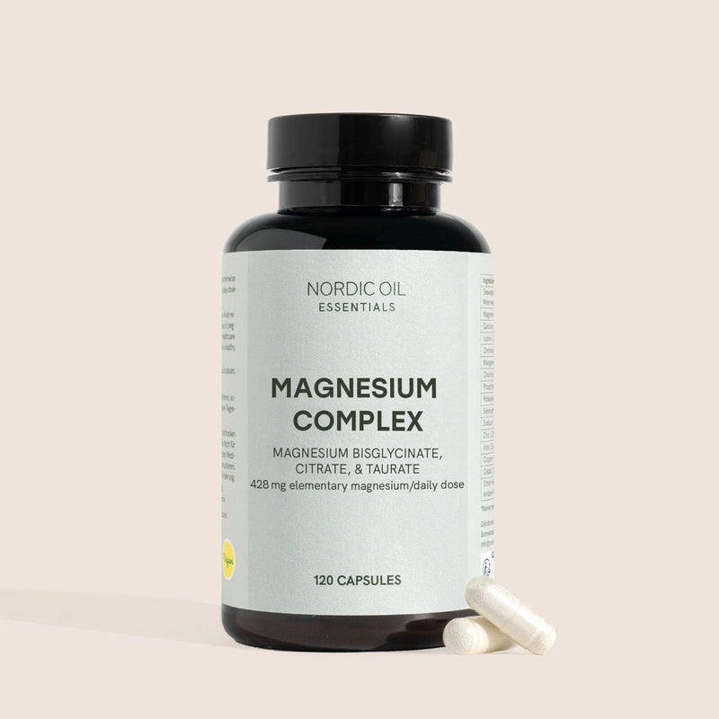 Bottiglia di integratore Magnesium Complex con capsule accanto